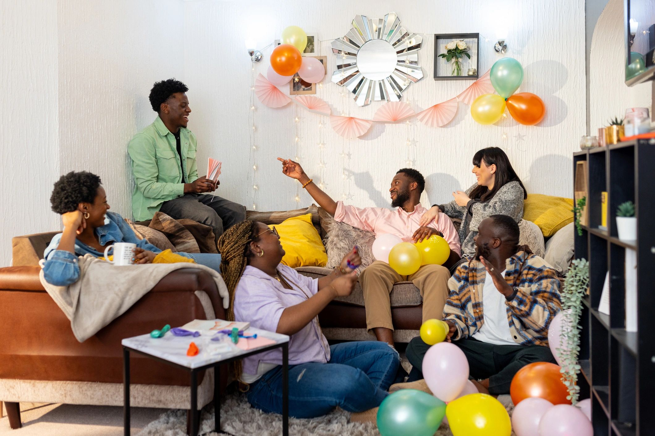 Friends preparing for a party and blowing up balloons